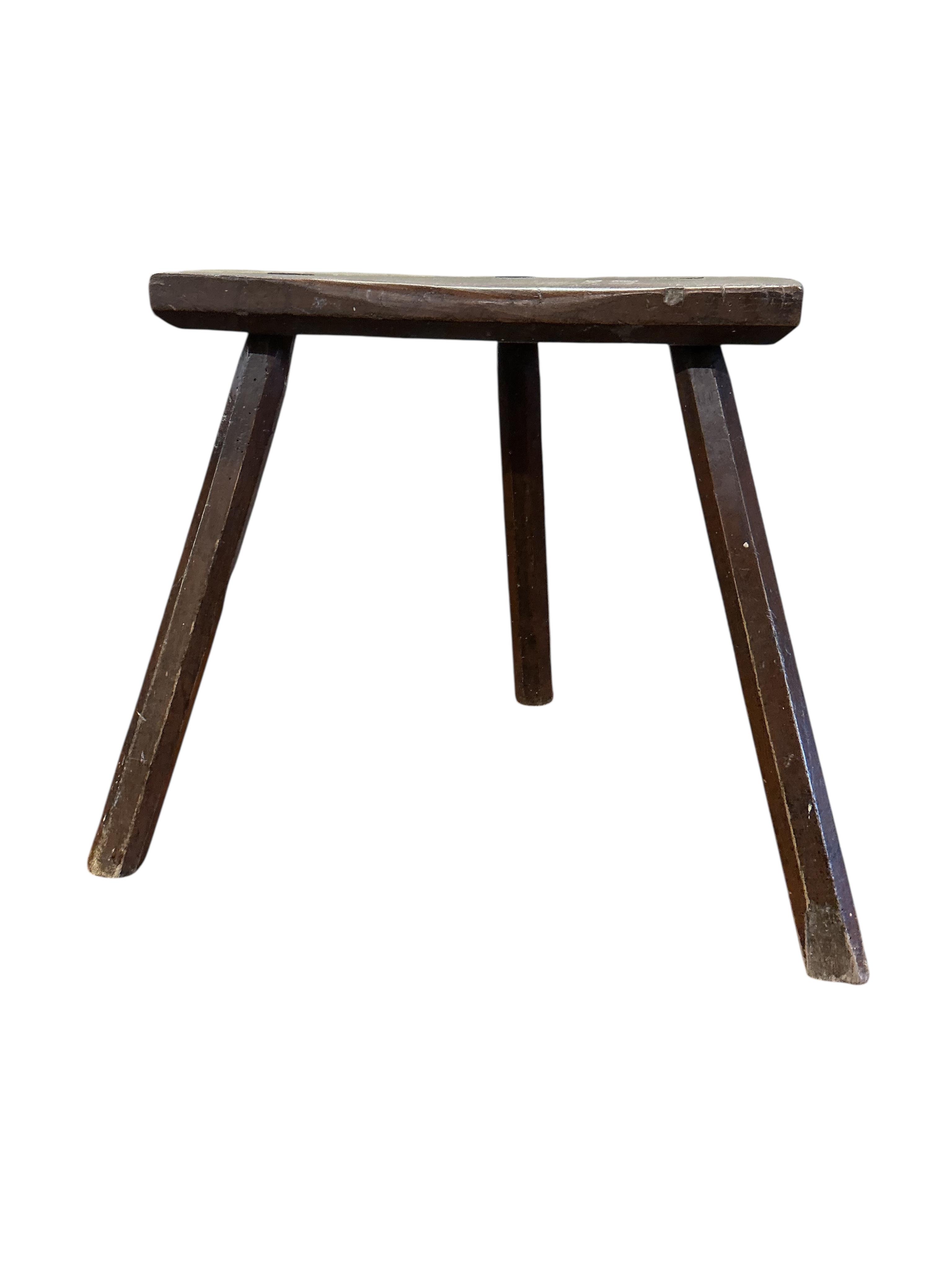 A 19th century elm and beech Provincial three legged stool, width 39cm, depth 23cm, height 40cm